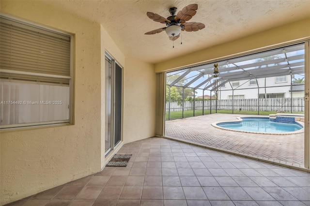 unfurnished sunroom with ceiling fan