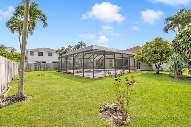 view of yard featuring glass enclosure, a fenced backyard, and a fenced in pool