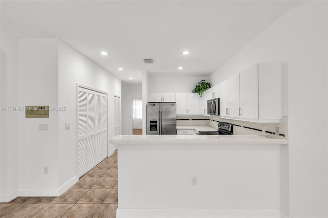 kitchen with light tile patterned floors, visible vents, white cabinets, light countertops, and appliances with stainless steel finishes