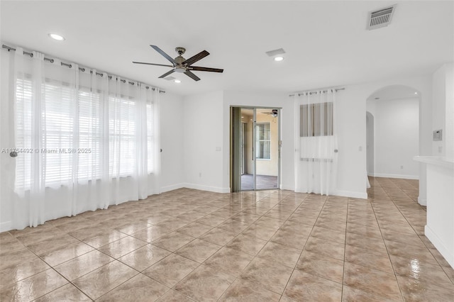 spare room with arched walkways, recessed lighting, visible vents, a ceiling fan, and light tile patterned flooring