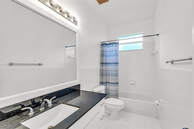 full bath with toilet, shower / tub combo with curtain, vanity, and tile walls