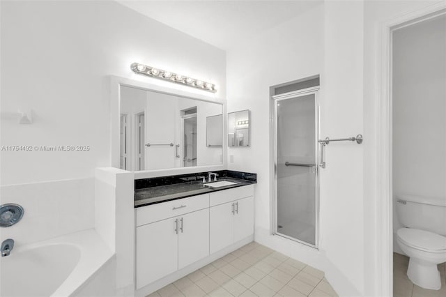 bathroom with toilet, tile patterned floors, a garden tub, vanity, and a shower stall