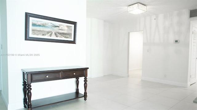 hall featuring baseboards