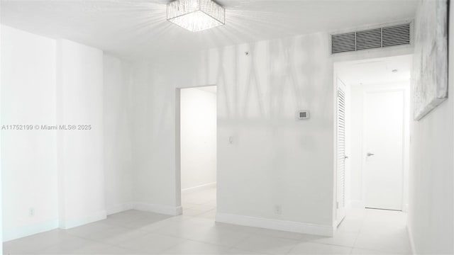 empty room with baseboards and visible vents