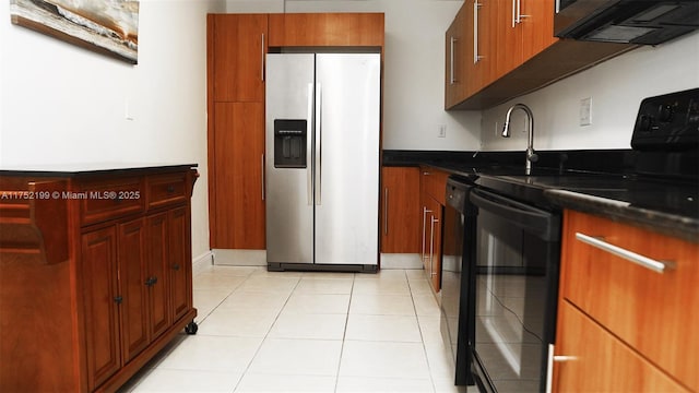 kitchen with dark countertops, black appliances, and light tile patterned floors