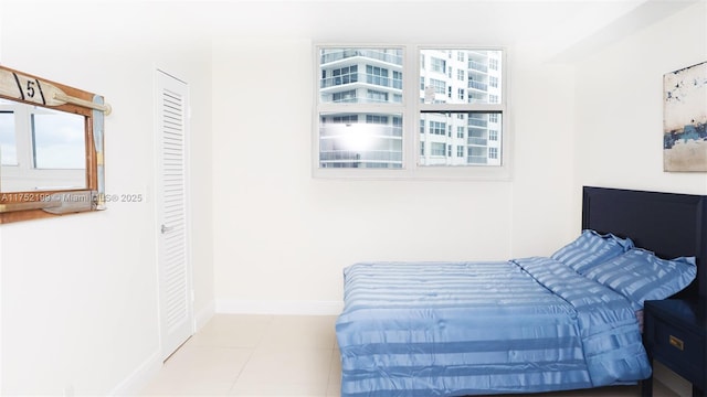 bedroom featuring tile patterned floors and baseboards
