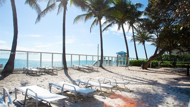 exterior space featuring a water view and a beach view
