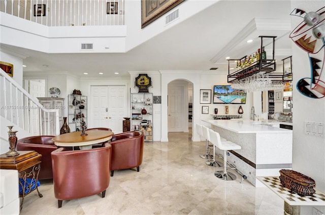 1468 Mariner Way, Hollywood, FL 33019 - living room with arched walkways, a high ceiling, bar, recessed lighting, and stairway