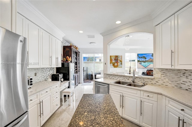 1468 Mariner Way, Hollywood, FL 33019 - kitchen featuring stainless steel appliances, ornamental molding, backsplash, white cabinetry, and recessed lighting