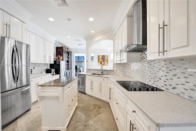1468 Mariner Way, Hollywood, FL 33019 - kitchen featuring appliances with stainless steel finishes, wall chimney exhaust hood, ornamental molding, tasteful backsplash, and a center island