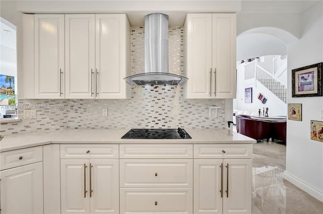 1468 Mariner Way, Hollywood, FL 33019 - kitchen featuring wall chimney range hood, black electric stovetop, white cabinetry, and decorative backsplash