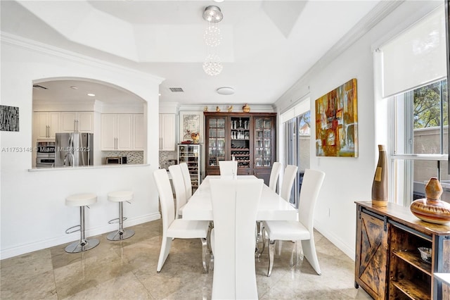 1468 Mariner Way, Hollywood, FL 33019 - dining room with a raised ceiling, crown molding, arched walkways, and a chandelier