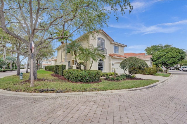 1468 Mariner Way, Hollywood, FL 33019 - view of home's exterior with curved driveway, stucco siding, a tile roof, and a garage
