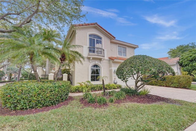 1468 Mariner Way, Hollywood, FL 33019 - mediterranean / spanish house featuring a balcony, a tiled roof, stucco siding, and decorative driveway