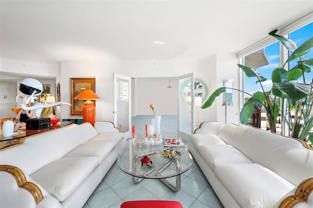 living area featuring floor to ceiling windows and tile patterned floors