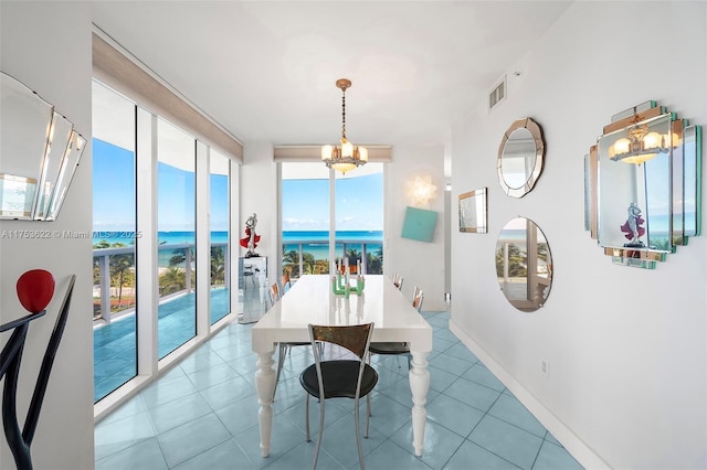 dining room with baseboards, floor to ceiling windows, visible vents, and tile patterned floors