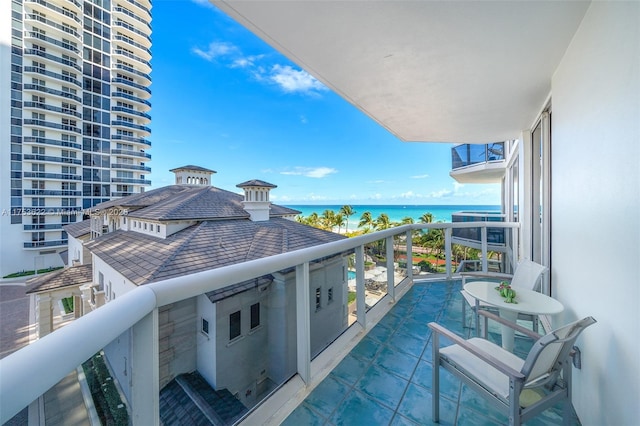 balcony featuring a water view and central AC