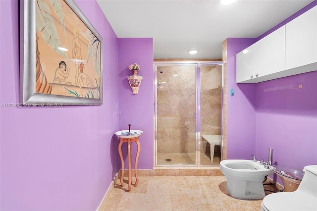 bathroom featuring tile patterned flooring, a bidet, a shower stall, and toilet