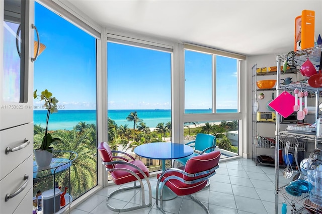 sunroom / solarium with a water view