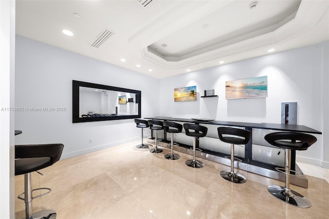 bar featuring recessed lighting, a raised ceiling, visible vents, and baseboards