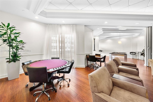 recreation room with beam ceiling, recessed lighting, hardwood / wood-style flooring, and baseboards