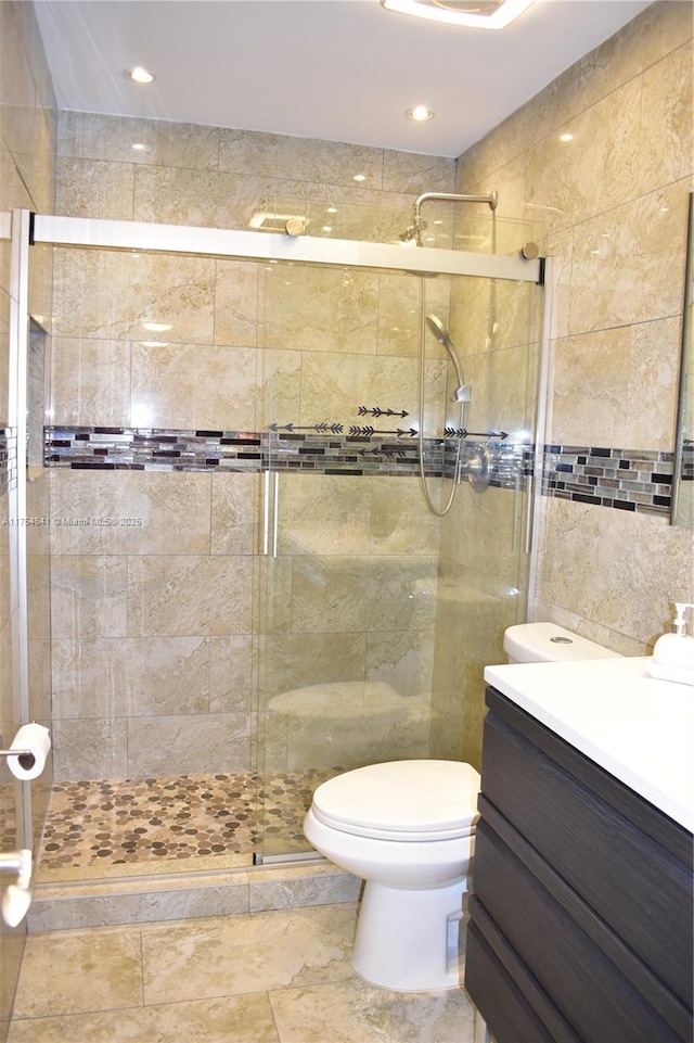 9320 Sunrise Lakes Blvd Unit 306, Sunrise, FL 33322 - bathroom featuring vanity, toilet, tile walls, recessed lighting, and a shower stall
