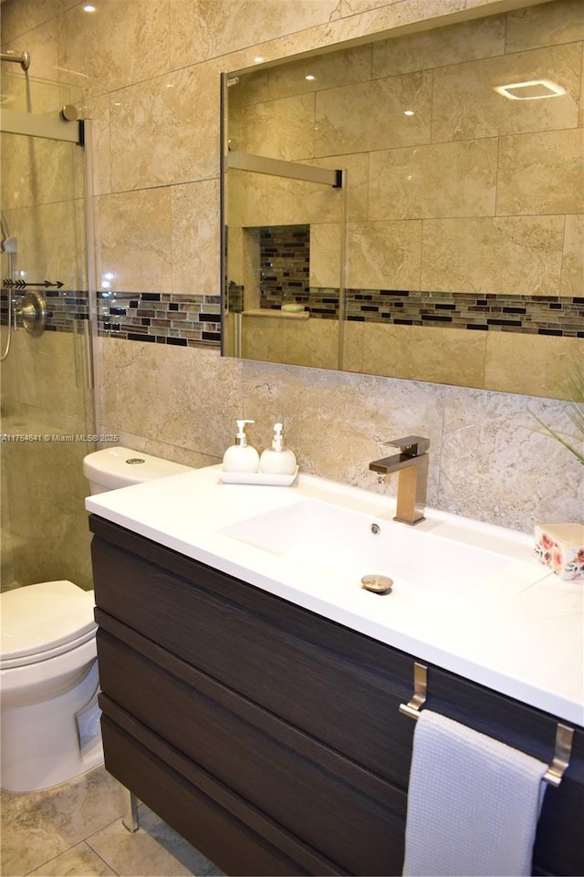 9320 Sunrise Lakes Blvd Unit 306, Sunrise, FL 33322 - bathroom featuring decorative backsplash, tile walls, a shower stall, vanity, and toilet