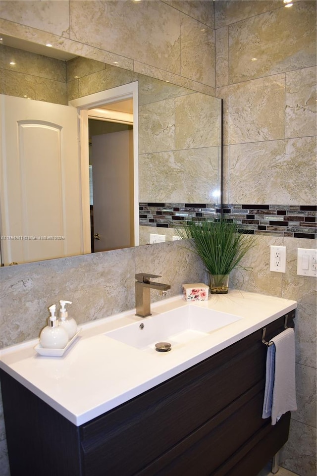 9320 Sunrise Lakes Blvd Unit 306, Sunrise, FL 33322 - bathroom with vanity, backsplash, and tile walls