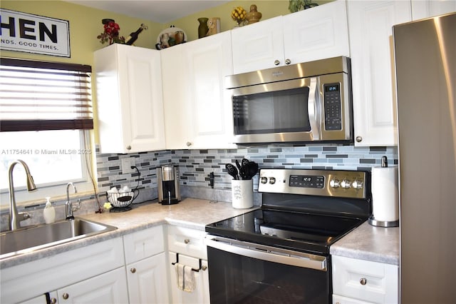 9320 Sunrise Lakes Blvd Unit 306, Sunrise, FL 33322 - kitchen with a sink, decorative backsplash, stainless steel appliances, and white cabinetry