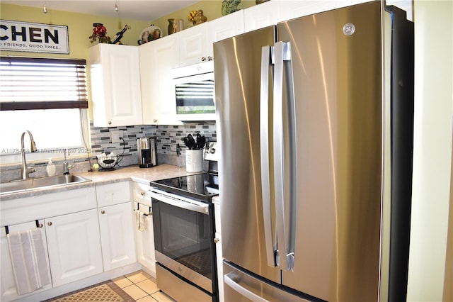 9320 Sunrise Lakes Blvd Unit 306, Sunrise, FL 33322 - kitchen featuring a sink, light tile patterned floors, stainless steel appliances, and white cabinetry