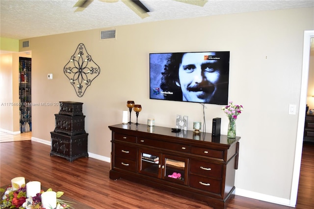 9320 Sunrise Lakes Blvd Unit 306, Sunrise, FL 33322 - living area with visible vents, baseboards, ceiling fan, dark wood-type flooring, and a textured ceiling