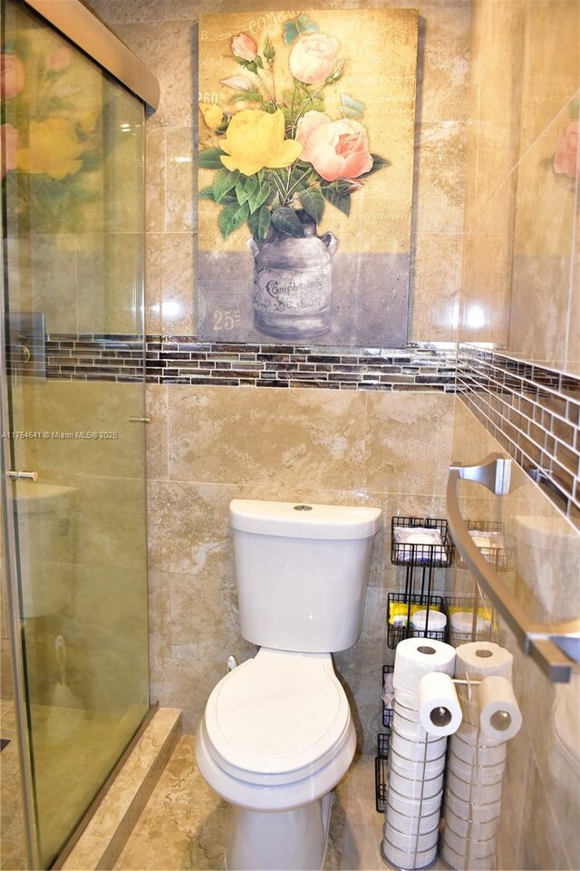9320 Sunrise Lakes Blvd Unit 306, Sunrise, FL 33322 - full bathroom featuring tile walls, a shower stall, and toilet