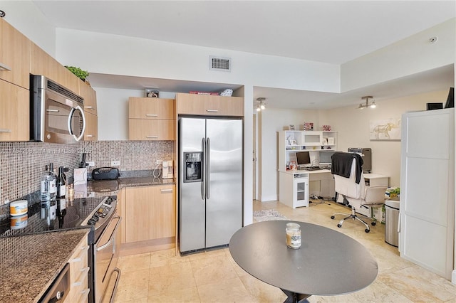 kitchen featuring visible vents, decorative backsplash, appliances with stainless steel finishes, dark stone countertops, and light brown cabinets
