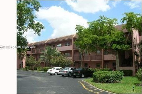 view of building exterior featuring uncovered parking