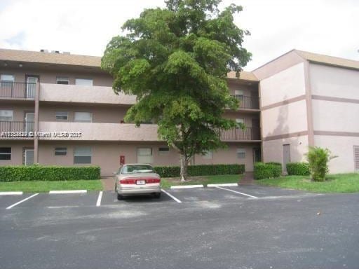 view of property featuring uncovered parking