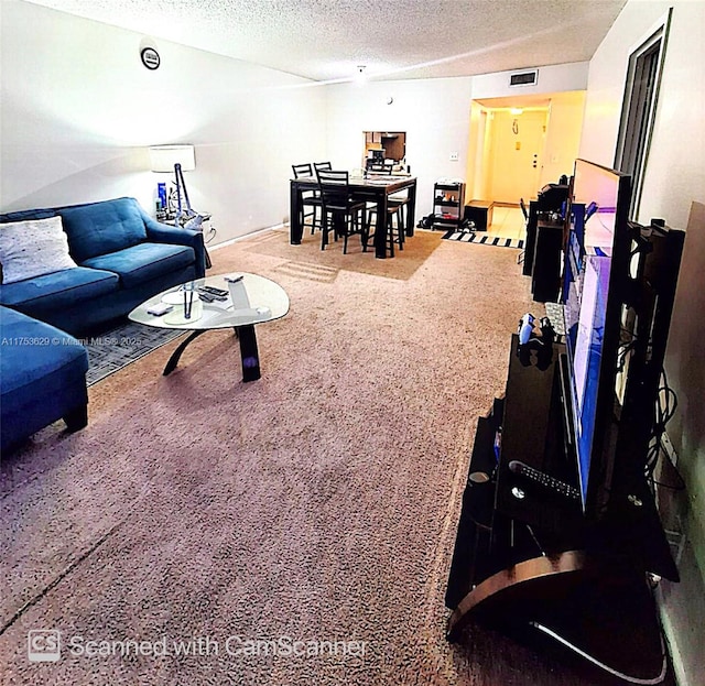 carpeted living room with visible vents and a textured ceiling