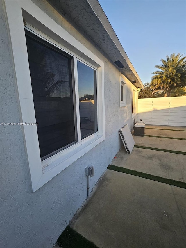 view of home's exterior featuring fence and stucco siding