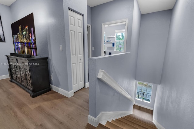 interior space with baseboards and wood finished floors