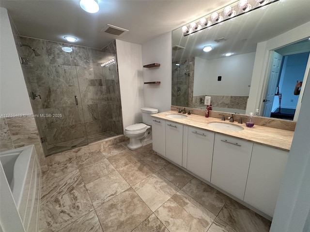 full bath with double vanity, a sink, toilet, and a shower stall