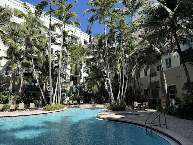 view of swimming pool featuring a community hot tub