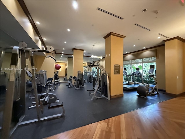 exercise room featuring recessed lighting, visible vents, crown molding, and wood finished floors