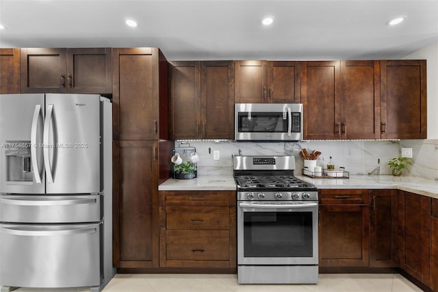 kitchen featuring appliances with stainless steel finishes, recessed lighting, dark brown cabinets, and decorative backsplash