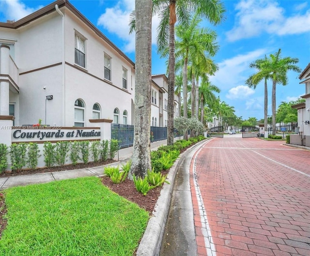 view of road with a gated entry and curbs