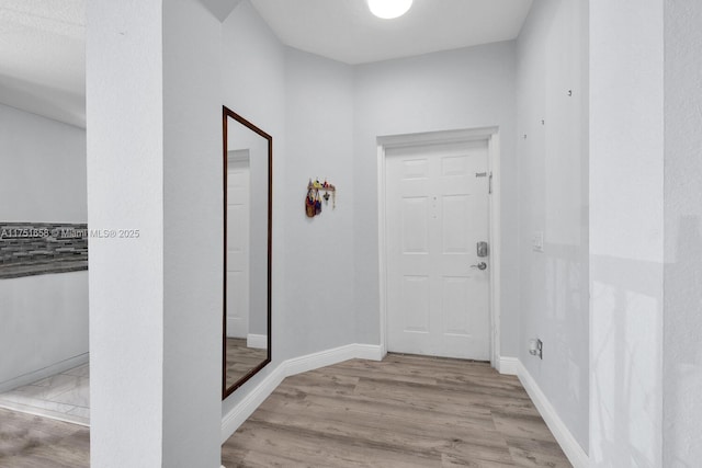 interior space with baseboards and wood finished floors