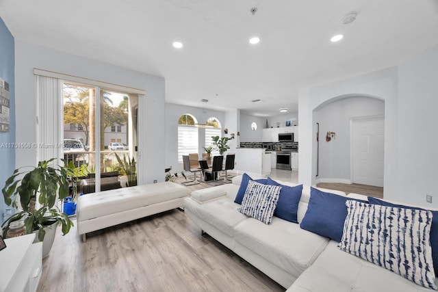 4331 SW 160th Ave Unit 108, Miramar, FL 33027 - living area featuring recessed lighting, arched walkways, light wood-type flooring, and baseboards