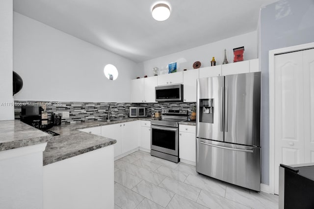4331 SW 160th Ave Unit 108, Miramar, FL 33027 - kitchen with appliances with stainless steel finishes, a sink, light marble finish flooring, white cabinetry, and decorative backsplash