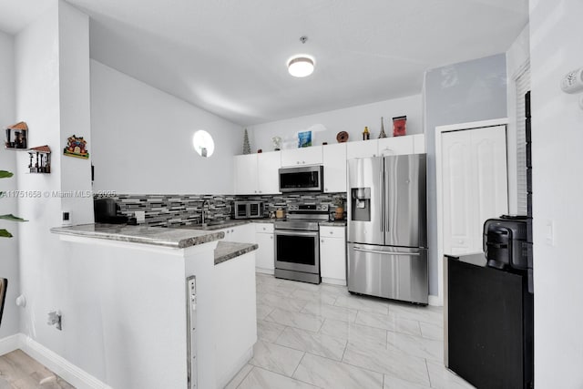 4331 SW 160th Ave Unit 108, Miramar, FL 33027 - kitchen featuring stainless steel appliances, white cabinets, backsplash, a peninsula, and a sink