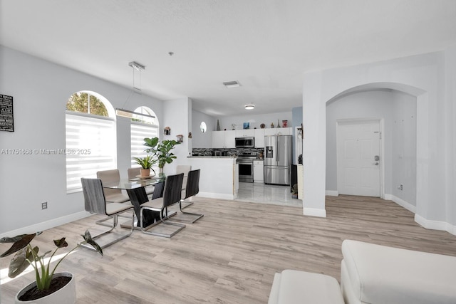 4331 SW 160th Ave Unit 108, Miramar, FL 33027 - living area with arched walkways, light wood-style flooring, and baseboards