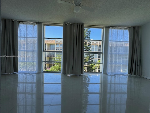851 Three Islands Blvd Unit 411, Hallandale Beach, FL 33009 - empty room with a textured ceiling, a ceiling fan, and expansive windows