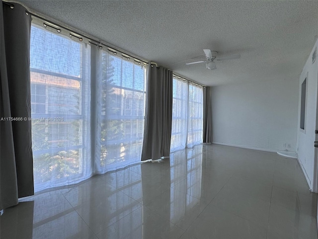 851 Three Islands Blvd Unit 411, Hallandale Beach, FL 33009 - tiled empty room with ceiling fan, a textured ceiling, and plenty of natural light